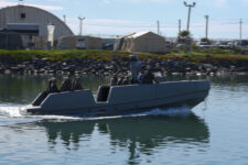 Marine scouts check out small boats from Down Under